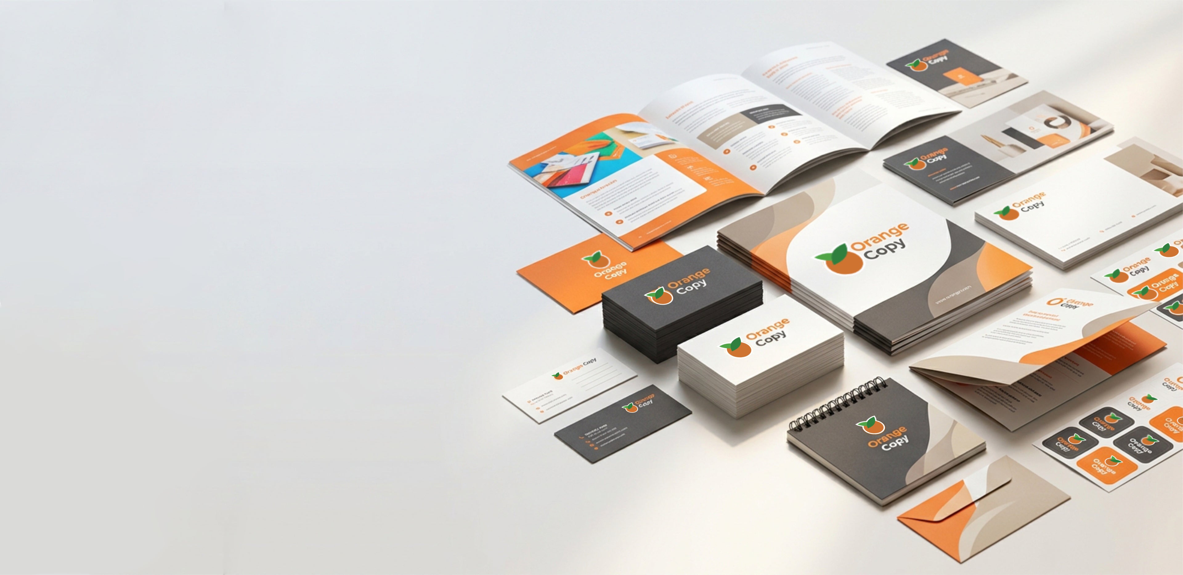 Collection of branded stationery items including business cards, brochures, and envelopes on a light gray background.